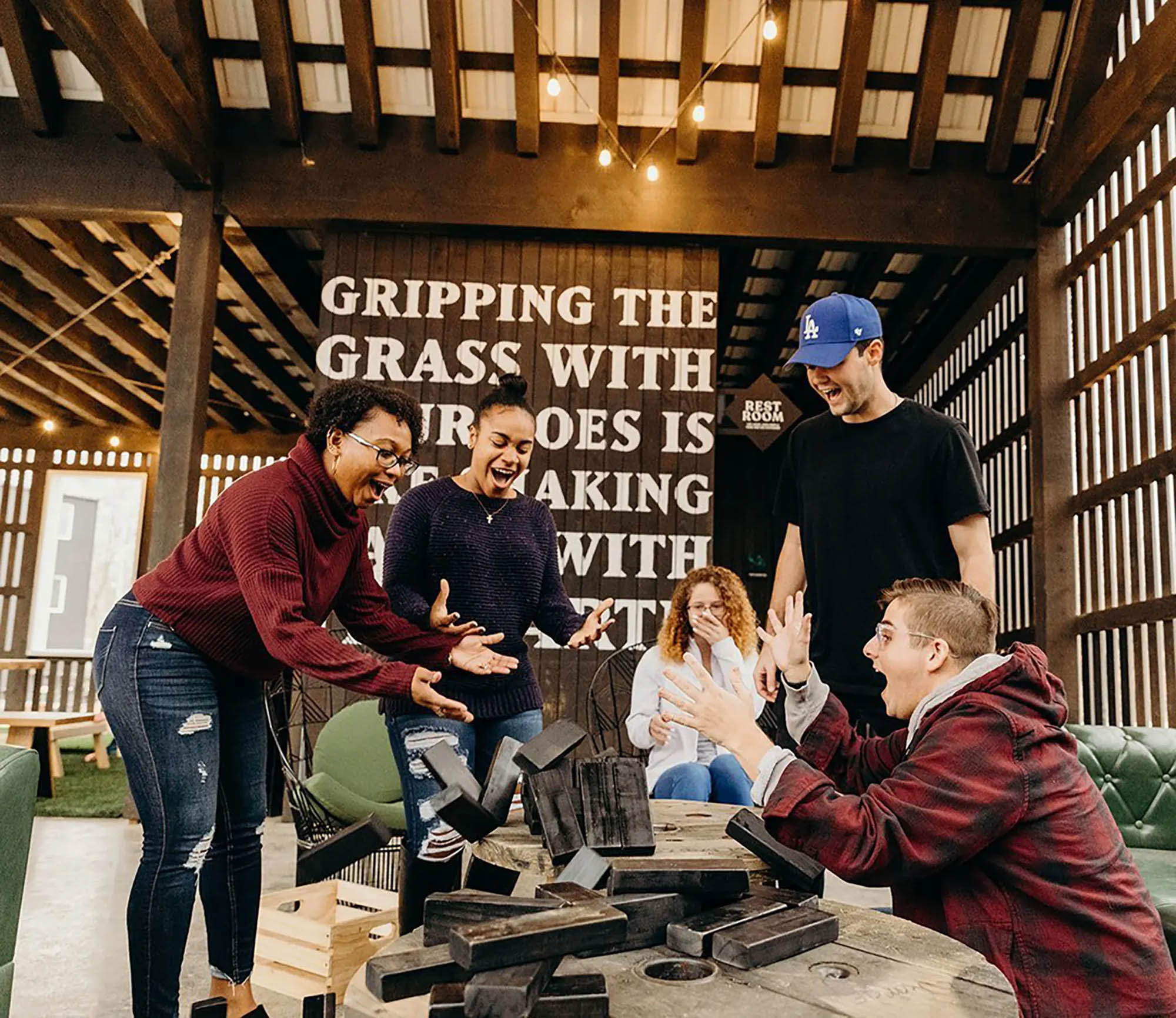 Residents playing Jenga outside in the outdoor clubhouse
